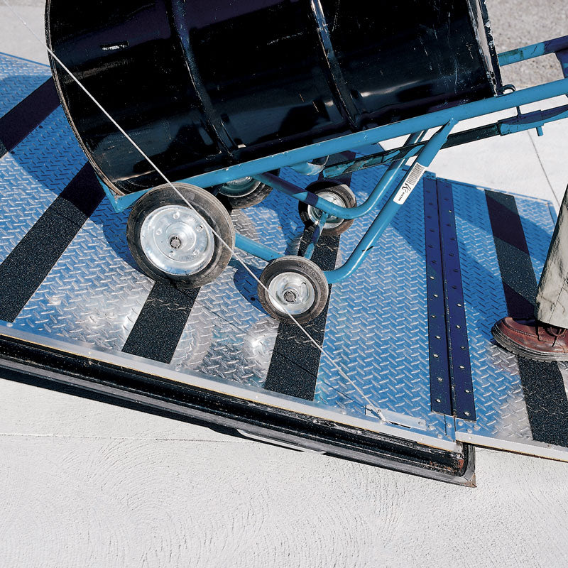 SG4104AL Gator Grip® Conformable Foil Backed Black Anti-Slip Grip Roll 46-grit Traction Tape (4 in x 60 ft) applied to diamond tread plate surface