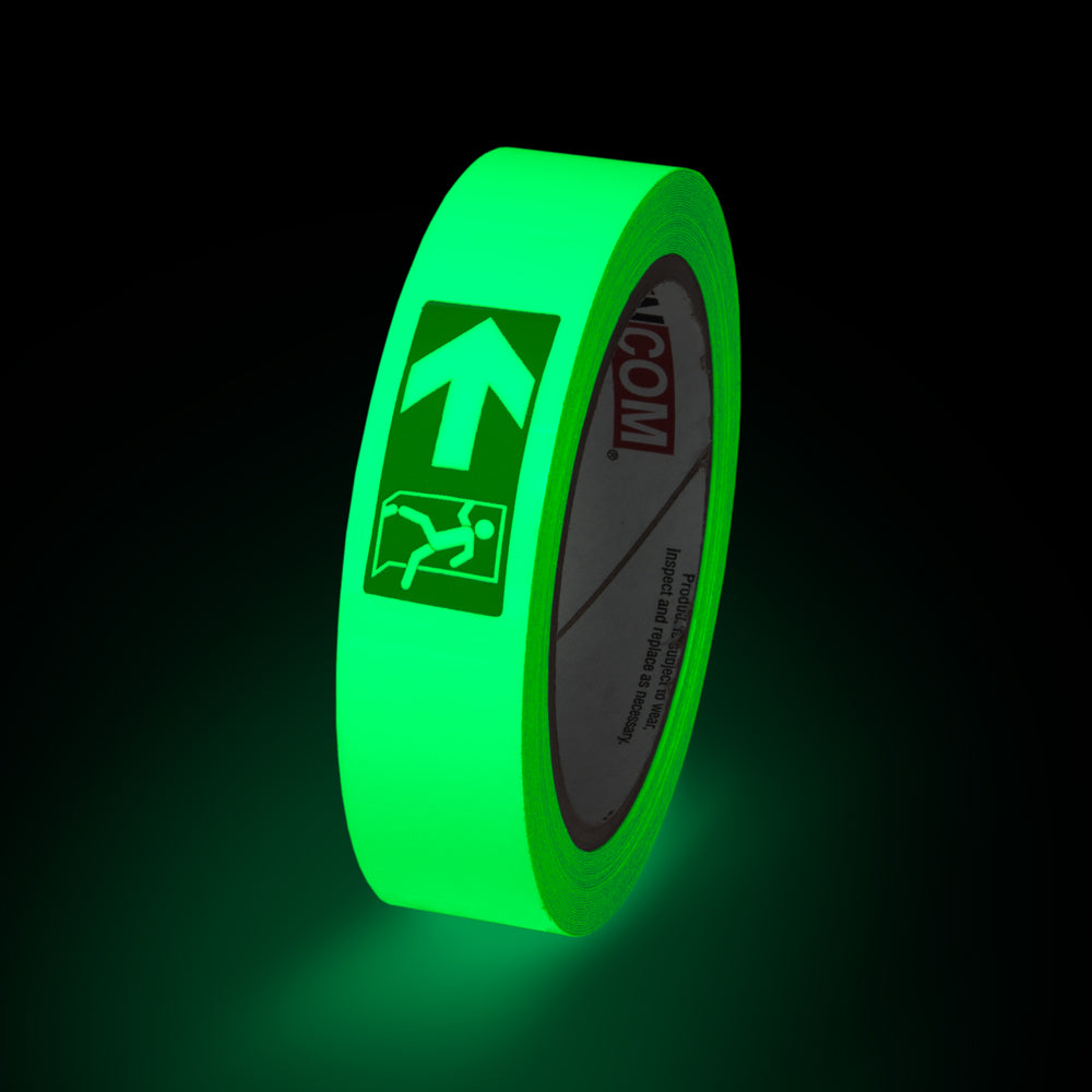 GT130EXL Fire Exit Left Directional Glow-in-the-Dark Phololuminescent Adhesive Safety Tape (1 in x 30 ft) glowing under low light conditions
