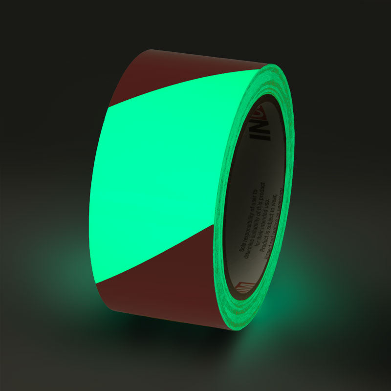 GT230RD Glow/Red Stripe Glow-in-the-Dark Phololuminescent Adhesive Safety Tape (2 in x 30 ft)  glowing under low light conditions