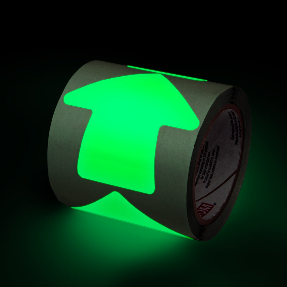 GTAR40 Glow-in-the-Dark Phololuminescent Adhesive Safety Tape 4 inch arrow Die Cut Shapes (100 /roll) showing glow feature in low light
