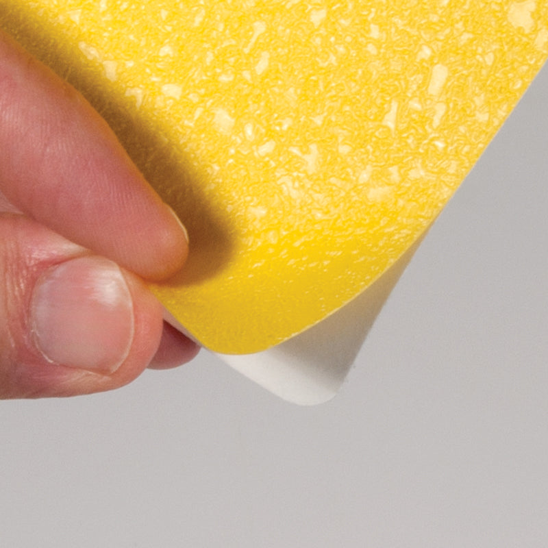 Yellow  "L" Shape 5S/Lean Textured Anti-Slip Grip Adhesive Warehouse Floor and Position Markers (25 /pkg) pealing up the corner off of the liner
