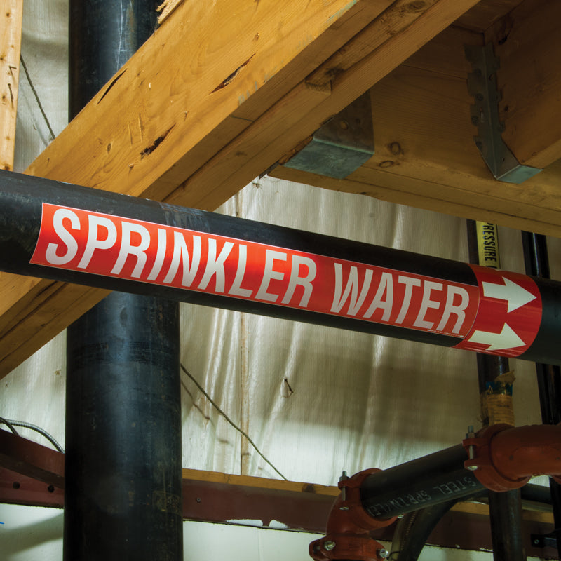PMA454 Red w/ White Arrow Pipe Marker Adhesive Directional Flow Arrows on a roll (4 in x 108 ft) applied to a SPRINKLER WATER pipe