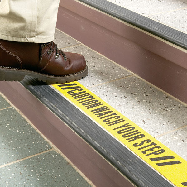 SG8903PT Gator Grip® Premium Worded Print WATCH YOUR STEP Yellow/Black Anti-Slip Grip Roll 60-grit Traction Tape (3 in x 60 ft) applied to stairs