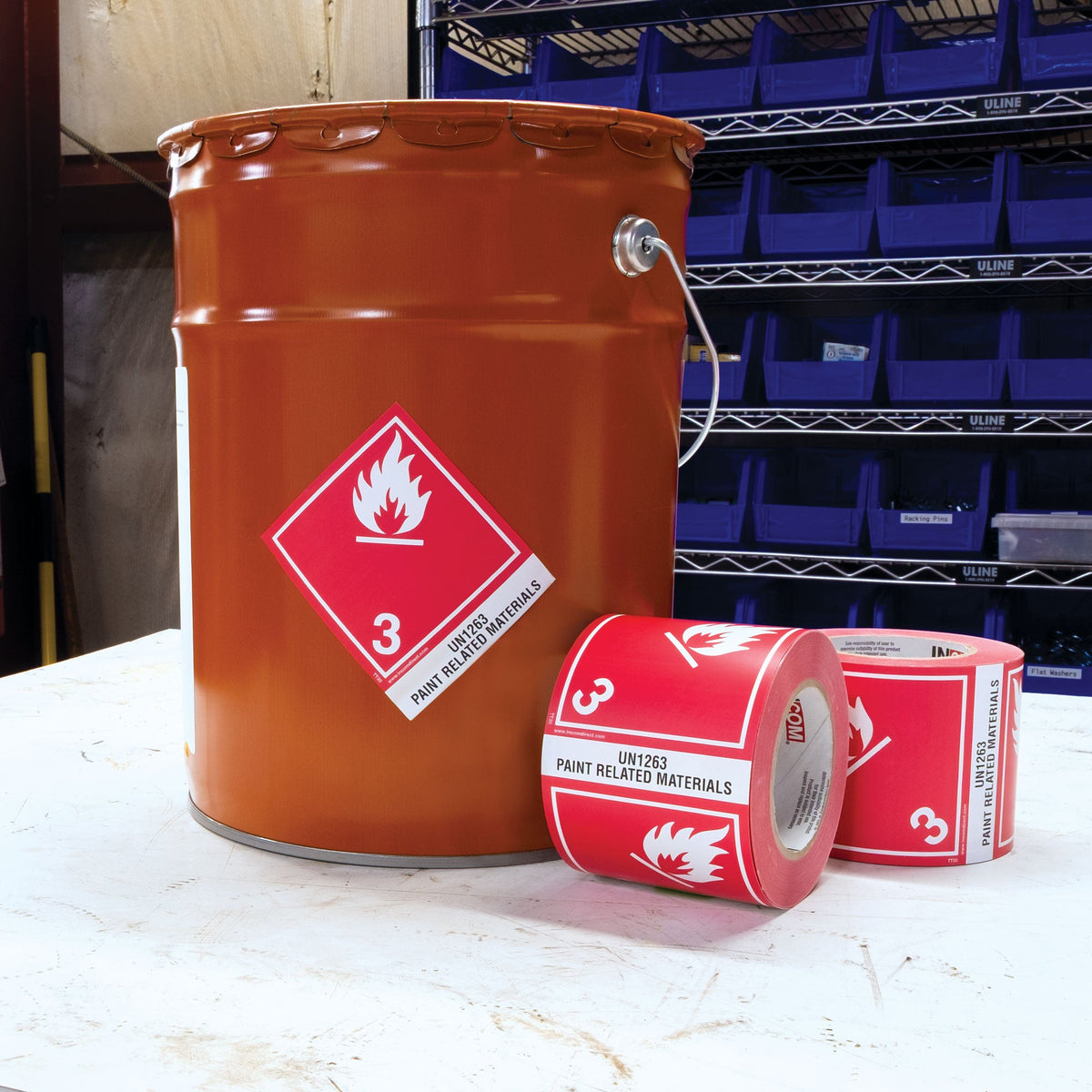 TDG Hazardous Material Canadian and International Preprinted Tabbed Shipping Labels (4 in x 4.75 in) 500 /roll in use on a bucket