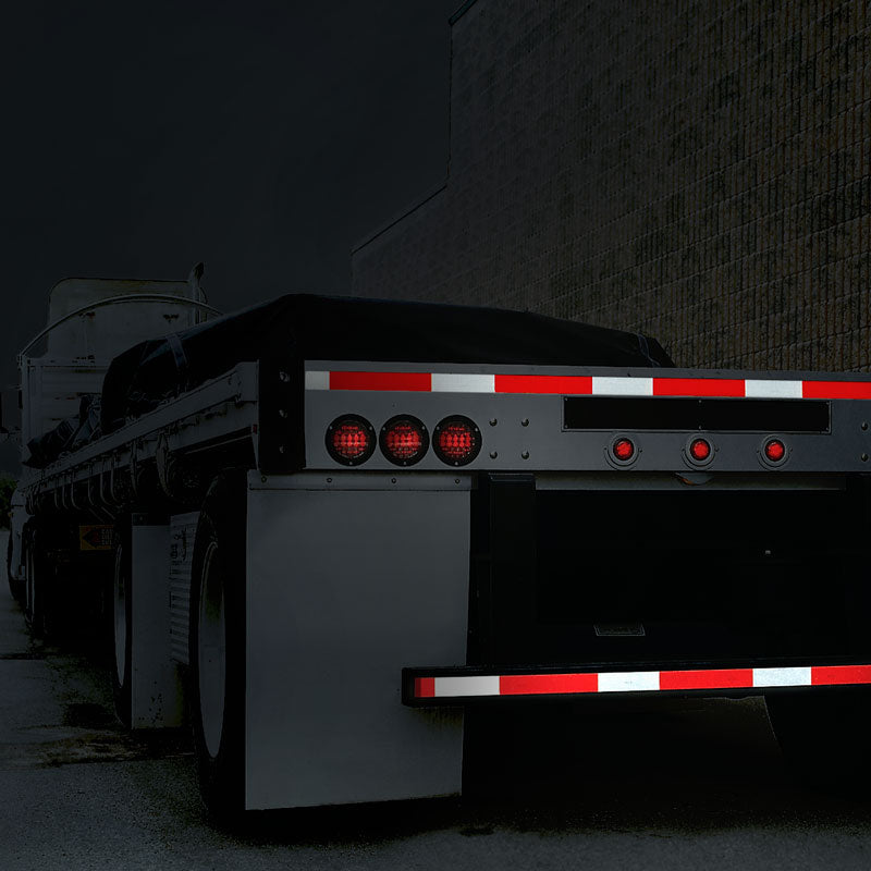 V572036 DOT Conspicuity Adhesive Reflective Trailer Tape (7in /11 in white/red pattern) 2 in x 150 ft applied to the side of a Flatbed Trailer seen at night