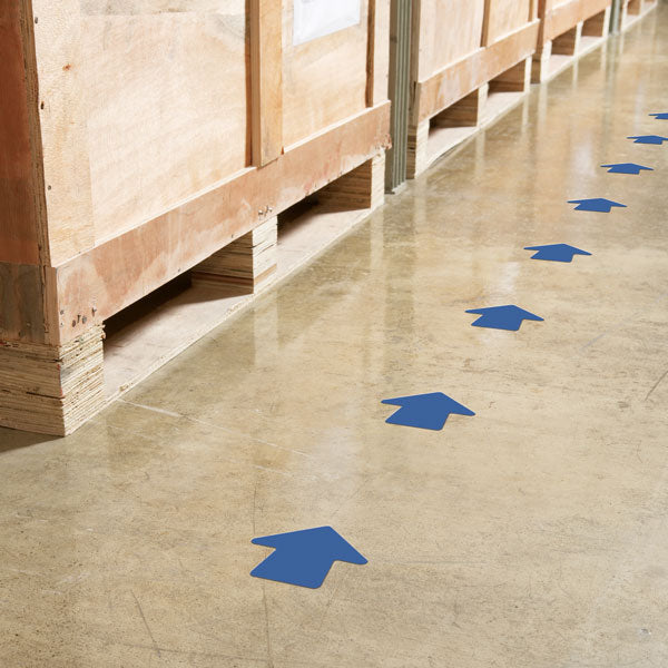 VA400B Blue Warehouse Floor and Lane Marking 4 inch Adhesive Arrow Shapes (100/roll) Applied to a Warehouse Floor Aisle for directional flow
