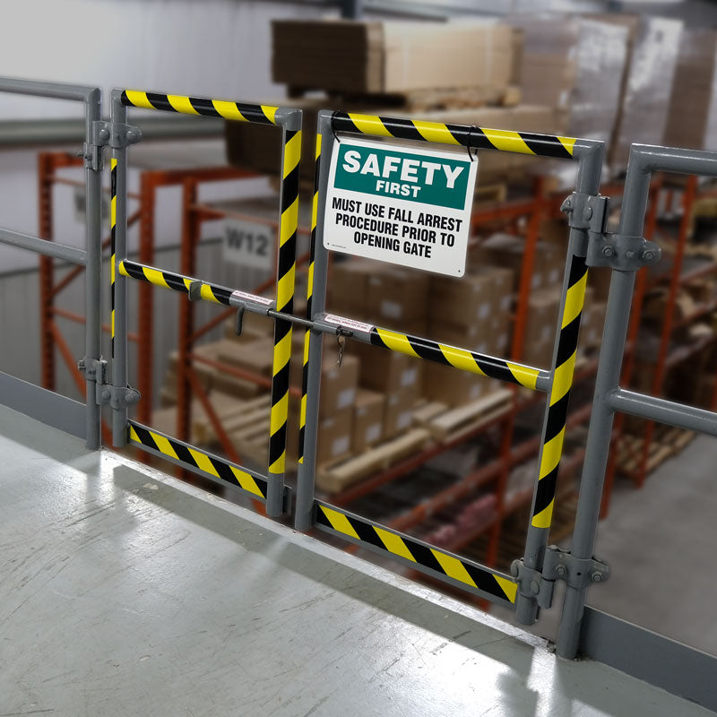 WT2110 Yellow/Black Conformable Adhesive Hazard Stripe Marking Tape (108 ft) applied to the rungs on a safety gate