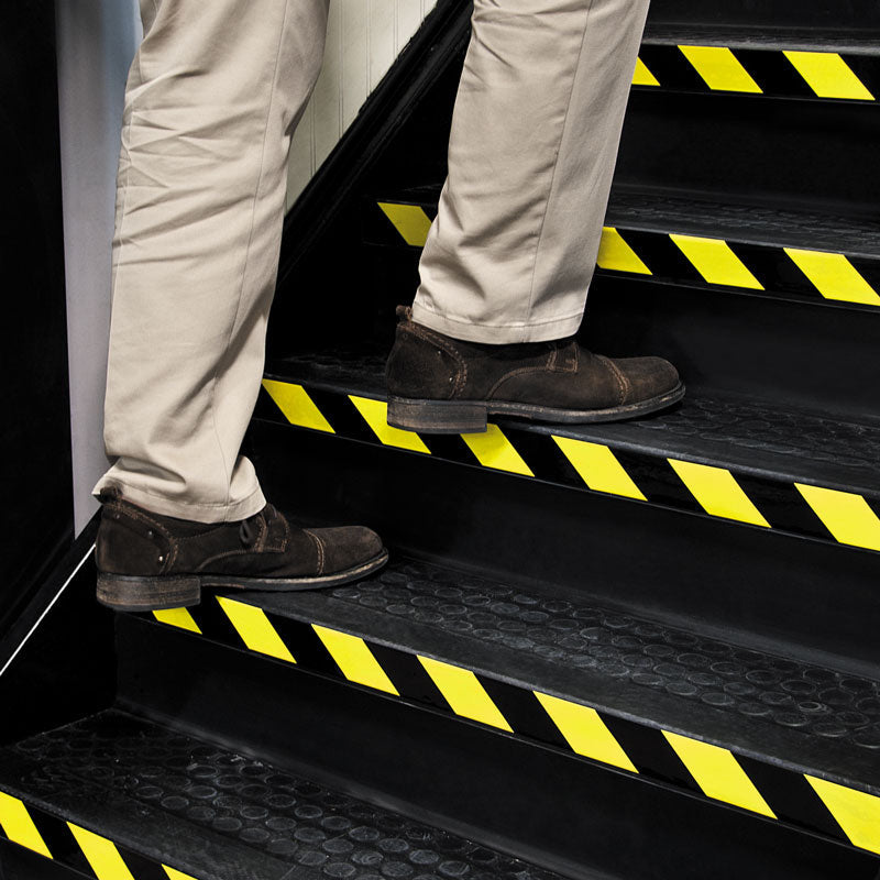 WT2110 Yellow/Black Conformable Adhesive Hazard Stripe Marking Tape (108 ft) applied to stair risers