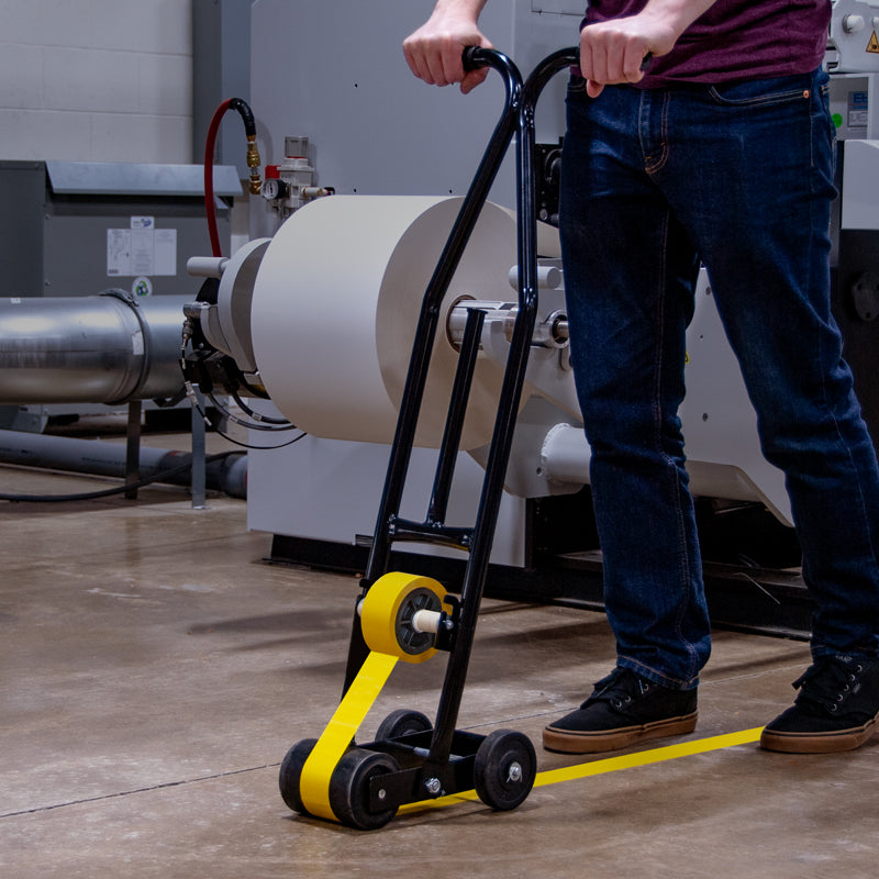 WTD200 Solid Steel Warehouse Lane Self-Wound Marking Tape Applicator being used in warehouse setting